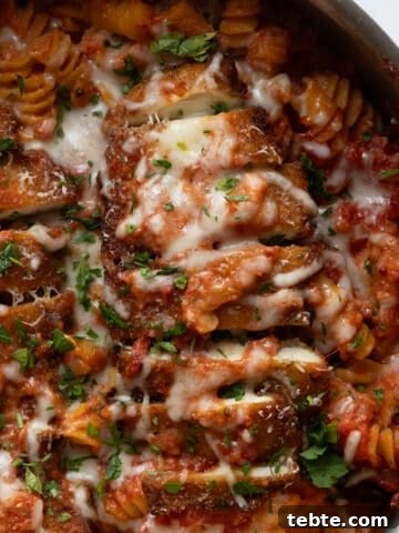 creamy chicken parmesan pasta in a skillet
