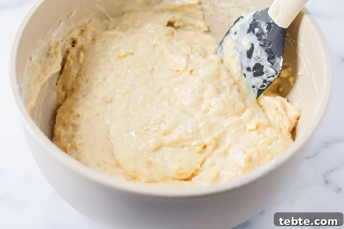 Cornbread batter in a gray bowl.