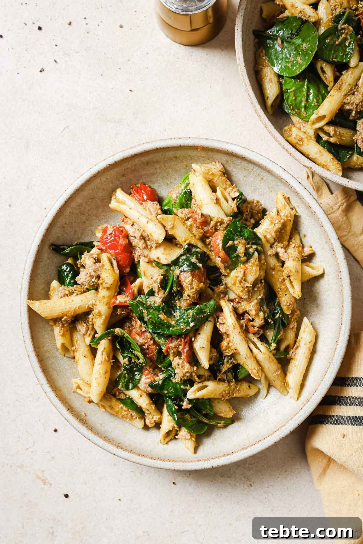 Creamy Tuna Pesto Pasta Recipe for Quick Weeknight Meals 10 Two bowls of pasta with spinach and tuna.