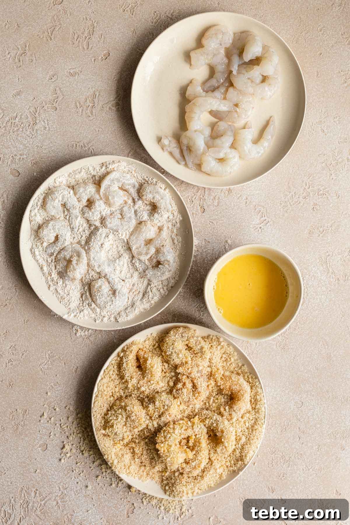 Crispy Air Fryer Breaded Shrimp Recipe for Quick Dinner 4 The process of breading the shrimp by coating in flour, egg and panko crumbs.