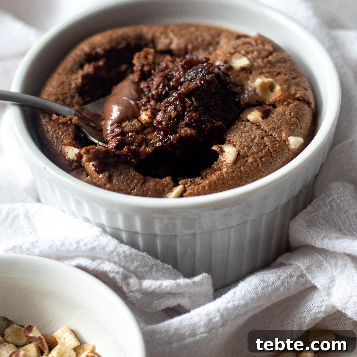 Nutella Baked Oats Recipe: Creamy Chocolate Hazelnut Breakfast 2 bowl of nutella baked oats with hazelnuts on top