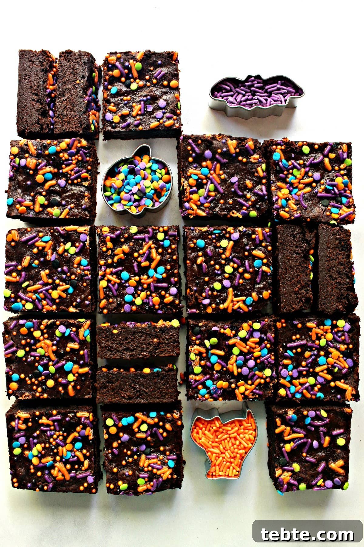 Pumpkin Fudge Brownies with Warm Spices and Gooey Center 2 Sliced Pumpkin Brownies with Halloween sprinkles.