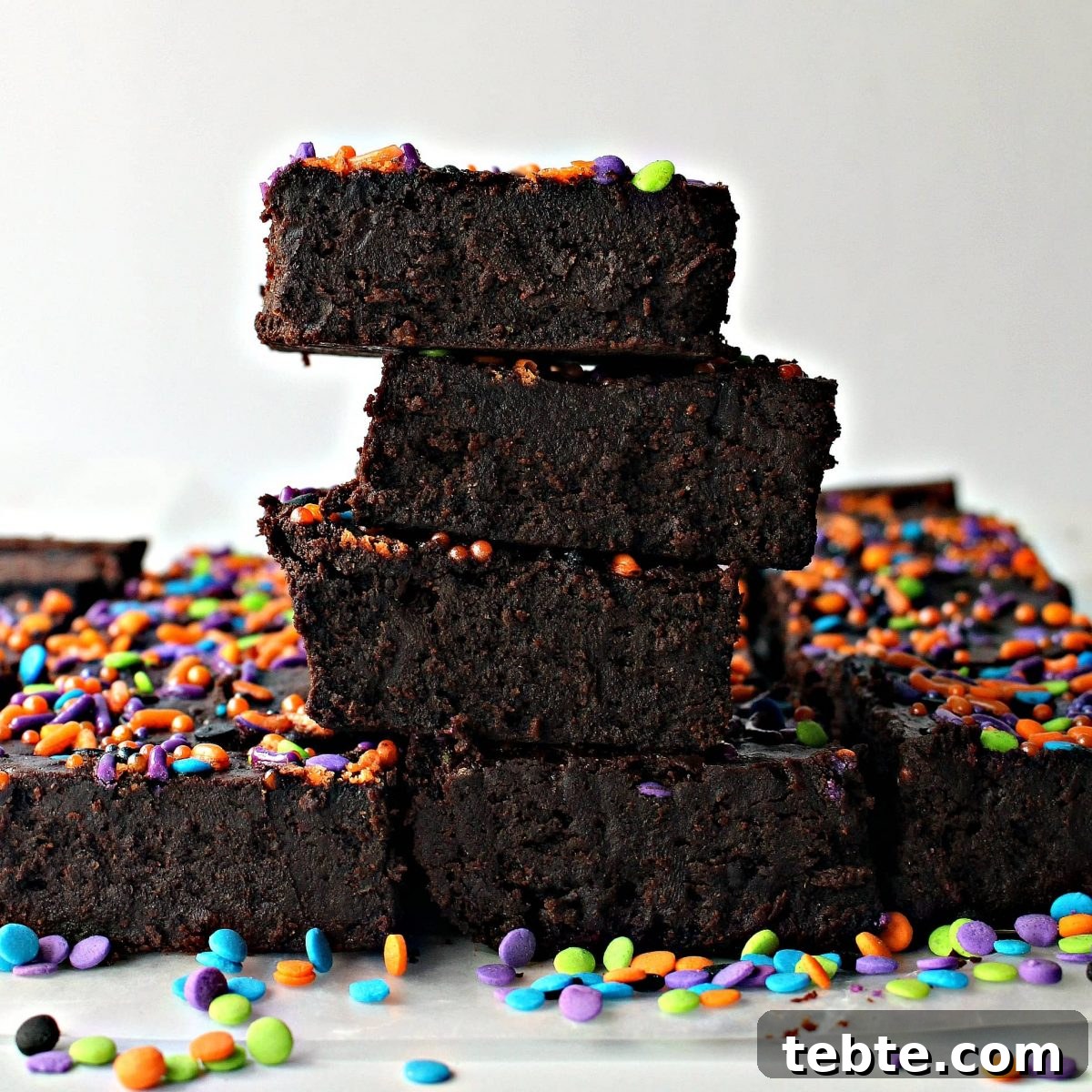 Pumpkin Fudge Brownies with Warm Spices and Gooey Center 5 View of cut edge of brownies in a stack.
