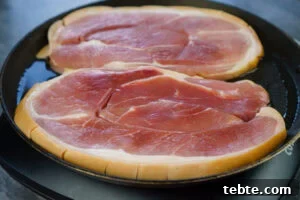 Classic Gammon Steak with Fried Egg and Chips 5 Cooking gammon steaks in a frying pan