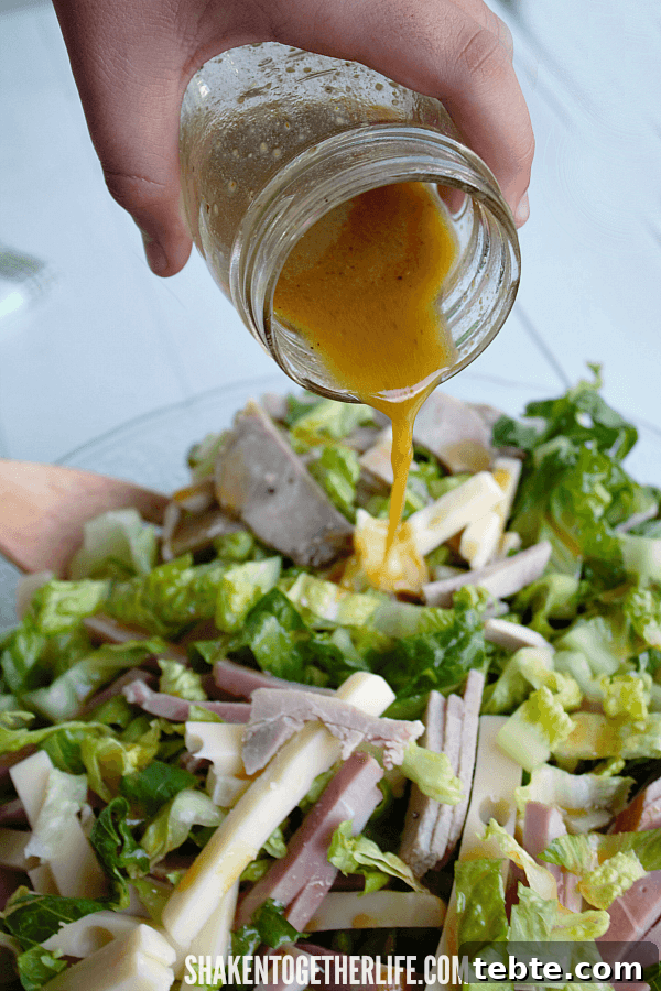 Cuban Cobb Salad with Zesty Mustard Vinaigrette 6 pouring a tangy mustard vinaigrette on a hearty, low carb Cuban Cobb Salad!