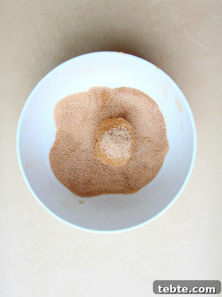 Pumpkin Cheesecake Cookies Recipe — Soft, Creamy Fall Treat 14 cinnamon sugar in white bowl with raw pumpkin cookie dough