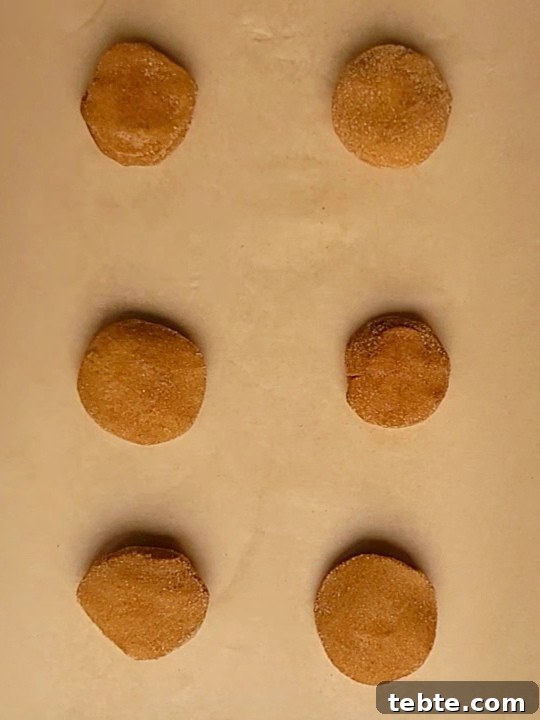 Pumpkin Cheesecake Cookies Recipe — Soft, Creamy Fall Treat 15 pumpkin cookies on brown parchment paper