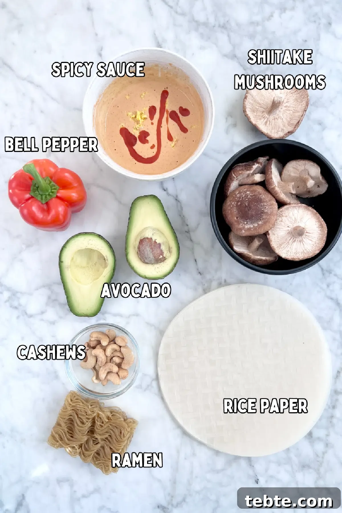 Avocado Shiitake Spring Rolls @spabettie #glutenfree #vegan #fresh #springroll #recipe Overhead view of ingredients for avocado shiitake spring rolls: spicy sauce, shiitake mushrooms, bell pepper, avocado, cashews, ramen noodles, round rice paper wrappers.