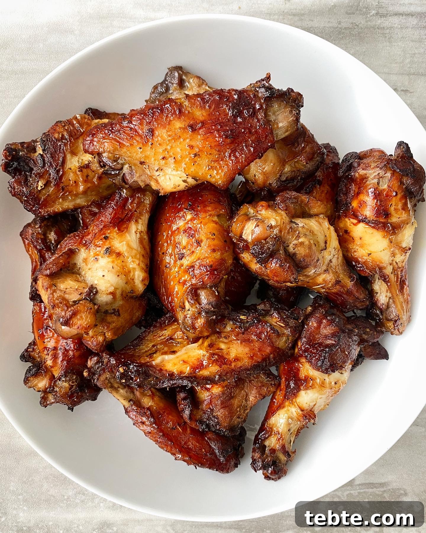 cooked marinated air fryer chicken in a white bowl