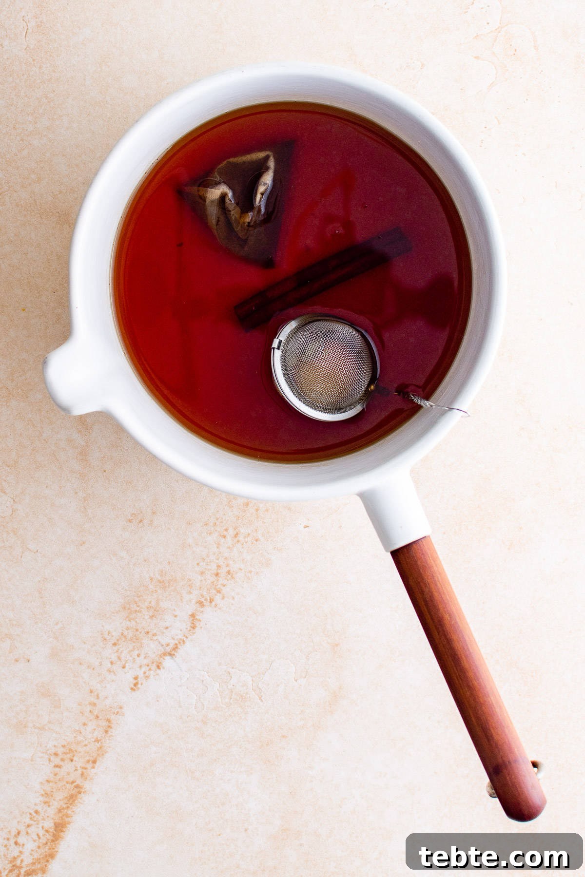 Refreshing Iced Chai Latte Recipe for Creamy Spiced Iced Tea 6 Top down view of spiced tea in a pan.