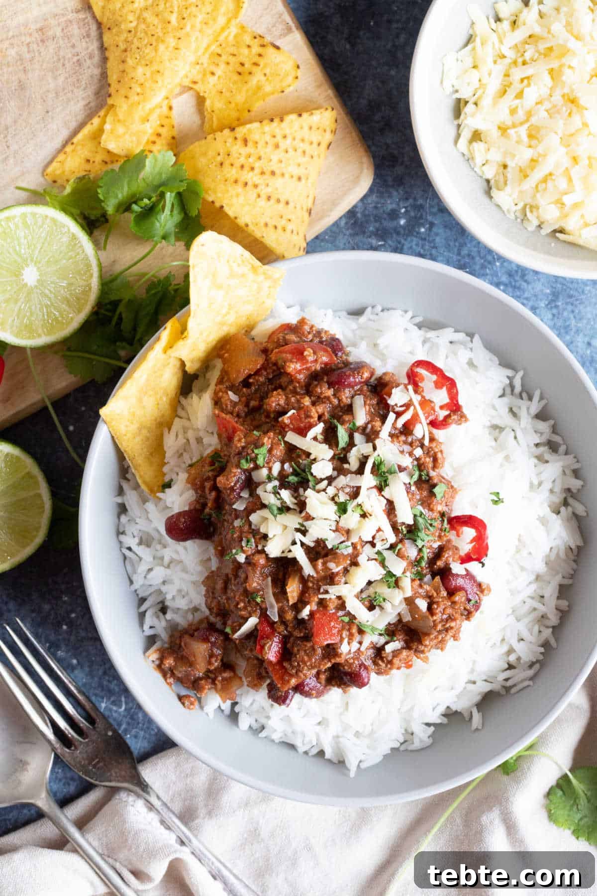 A bowl of slow cooked chilli on a bed of rice.