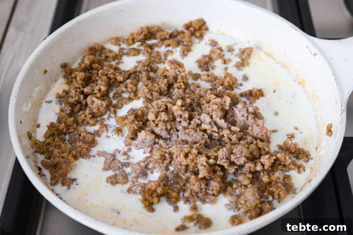 Forget the usual biscuits and gravy, this version takes everything you love and turns it into one irresistible, bubbly casserole. Creamy sausage gravy, buttery biscuits, and zero stress. Milk and cream added to the sausage and flour mixture.