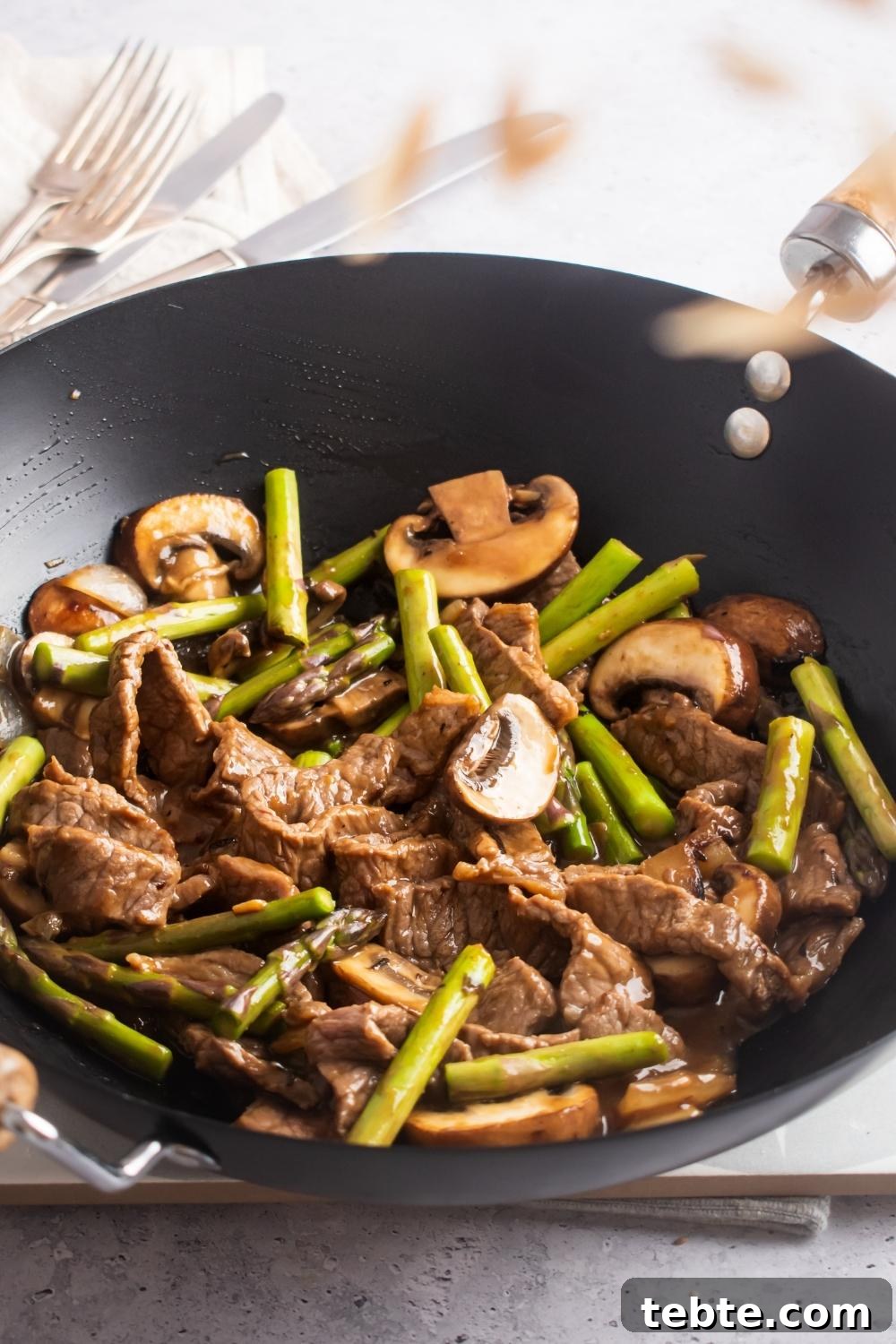 Panda Express Black Pepper Angus Steak Copycat Recipe 8 A wok filled angus steak, mushrooms, and asparagus.