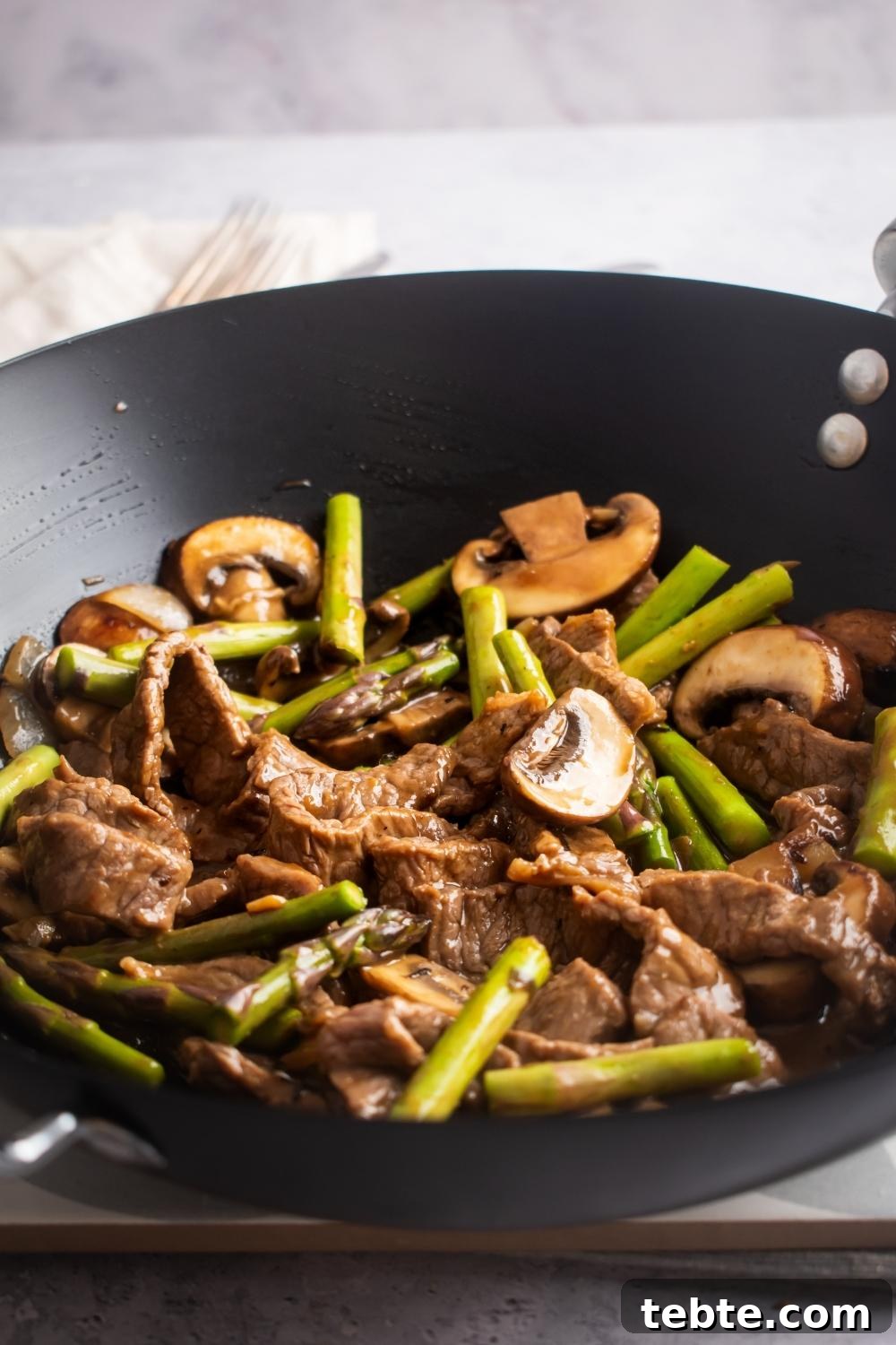 Panda Express Black Pepper Angus Steak Copycat Recipe 10 A close-up of a wok containing homemade panda express black pepper steak.