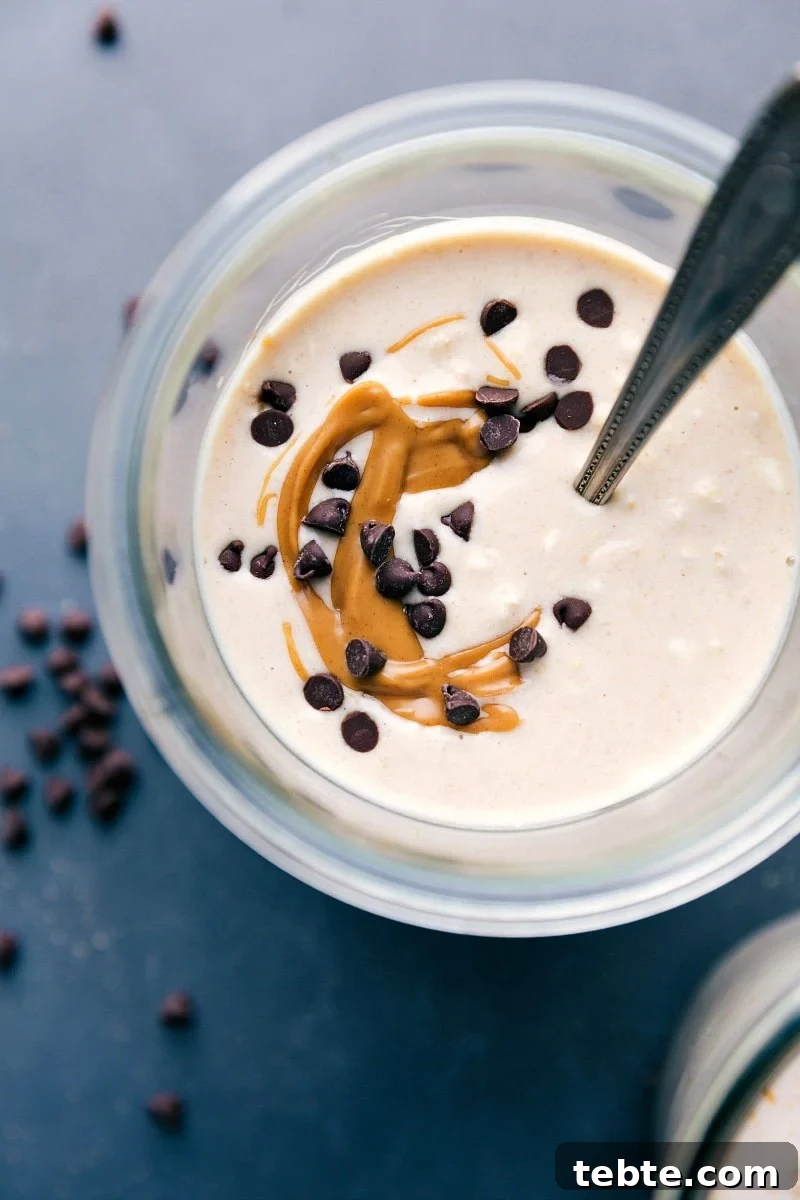 Finished peanut butter cheesecake overnight oats, adorned with a gorgeous peanut butter swirl and chocolate chips on top.