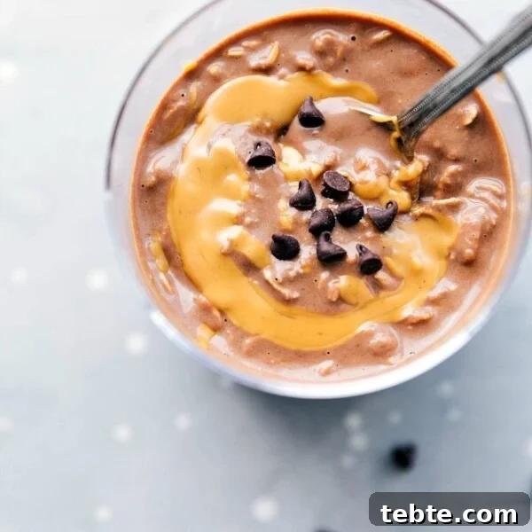 Peanut butter overnight oats, ready to be enjoyed on the go, with a peanut butter swirl mixed in and topped with chocolate chips.