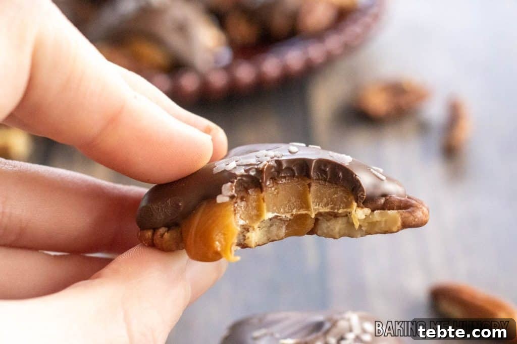 Chewy Pecan Caramel Candies Recipe for Homemade Treats 10 hand holding one of the pecan caramel candies missing a bite