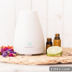 Tropical Essential Oil Diffuser Blends for Uplifting Scents 7 Diffuser with tropical oils and sliced limes.