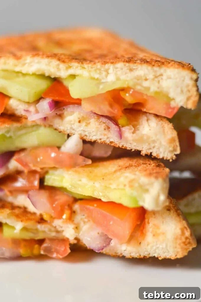 5-Minute Masala Sandwich Recipe: Spicy Indian Toasted Sandwich 3 A close up of a vegetable sandwich pile