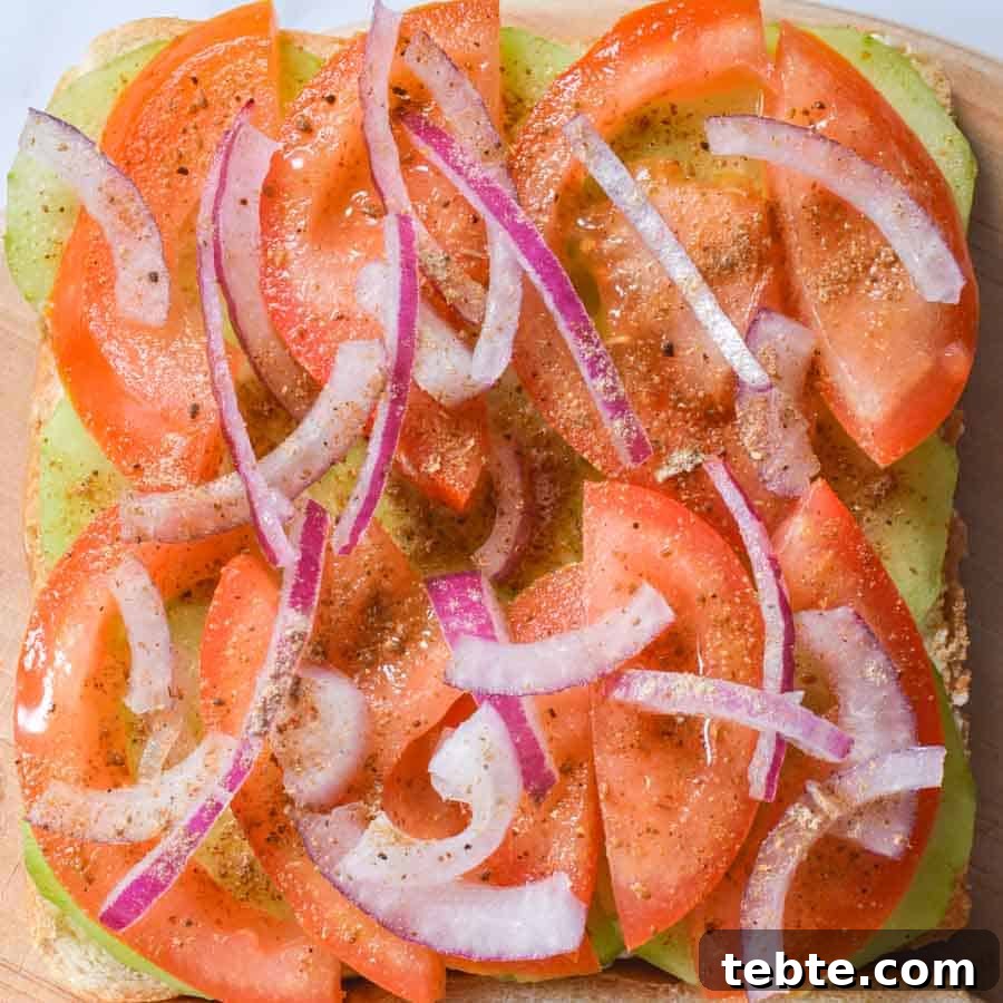5-Minute Masala Sandwich Recipe: Spicy Indian Toasted Sandwich 7 Tomatoes, onions and cucumbers sprinkled with chaat masala on a slice of buttered bread