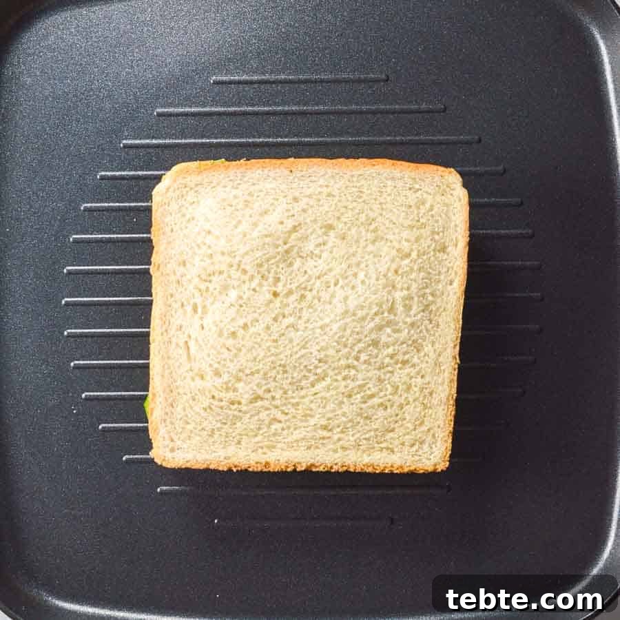 5-Minute Masala Sandwich Recipe: Spicy Indian Toasted Sandwich 8 A sandwich on a black grill pan