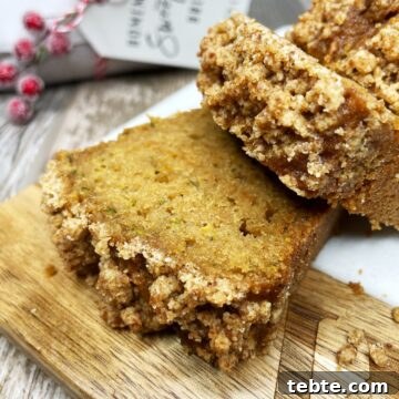 Sliced mini zucchini bread on a wooden board.