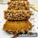 Sliced healthy pumpkin banana bread in a marble serving board.