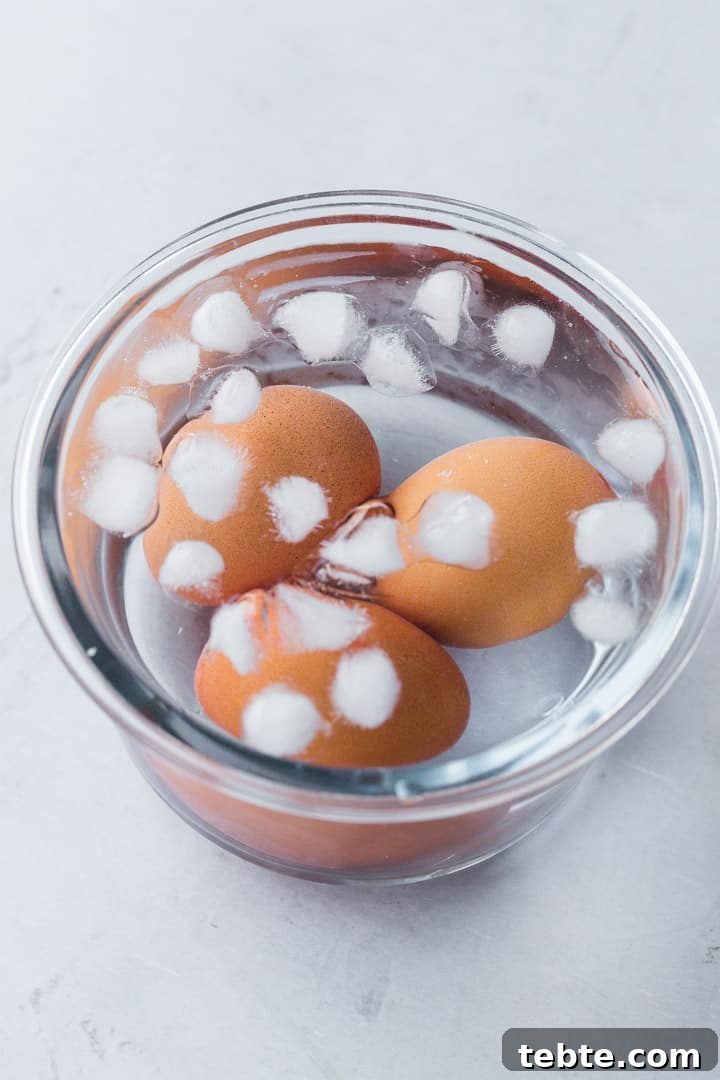 Perfect Hard-Boiled Eggs in the Instant Pot: Quick Guide 4 3 eggs in a glass bowl in an ice cold water bath