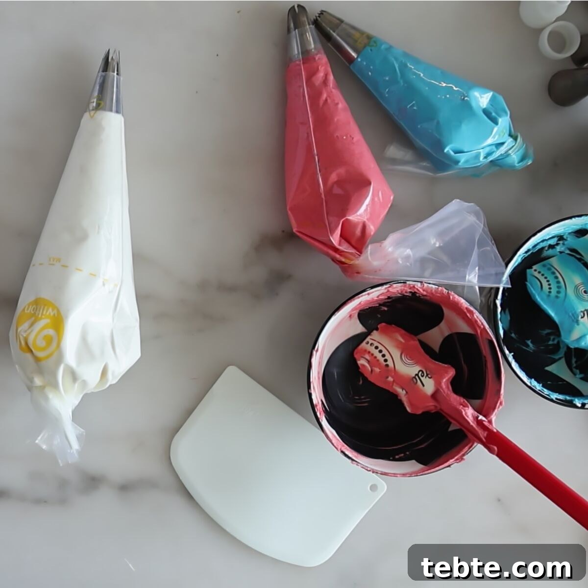 Gluten-Free Flag Cookie Cake Recipe for Patriotic Celebrations 12 red, white, and blue frosting in decorating bags.