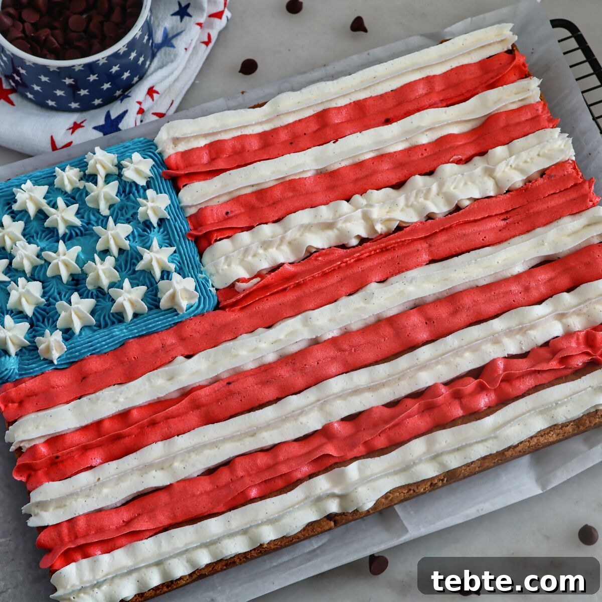 Gluten-Free Flag Cookie Cake Recipe for Patriotic Celebrations 14 whole cookie flag cake on wire rack with chocolate chips all around.