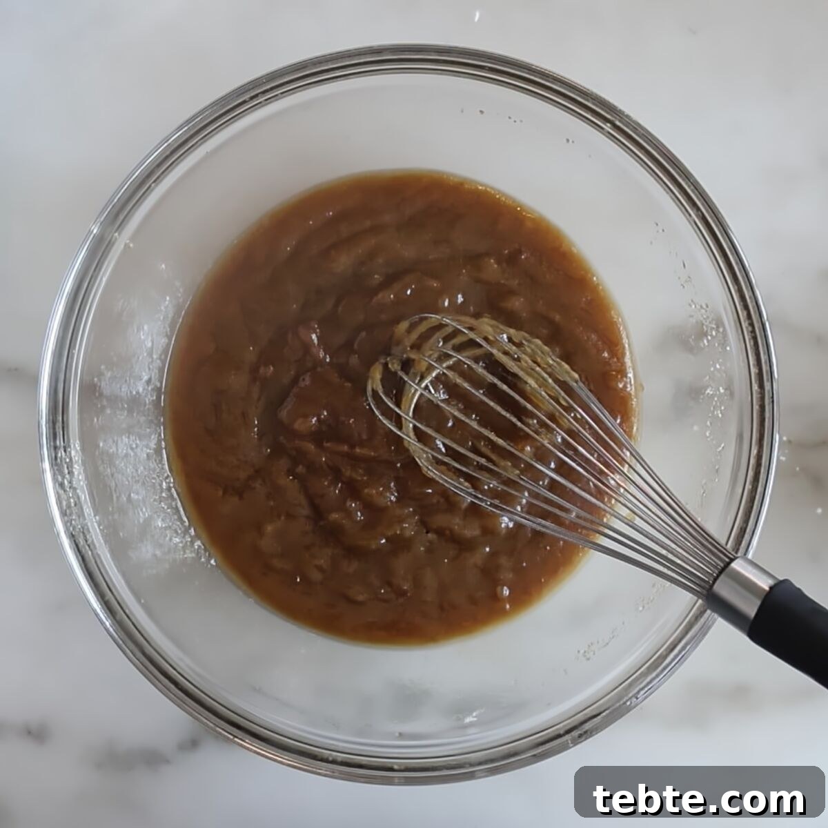 Gluten-Free Flag Cookie Cake Recipe for Patriotic Celebrations 6 brown thick mixture in bottom of glass bowl with whisk.