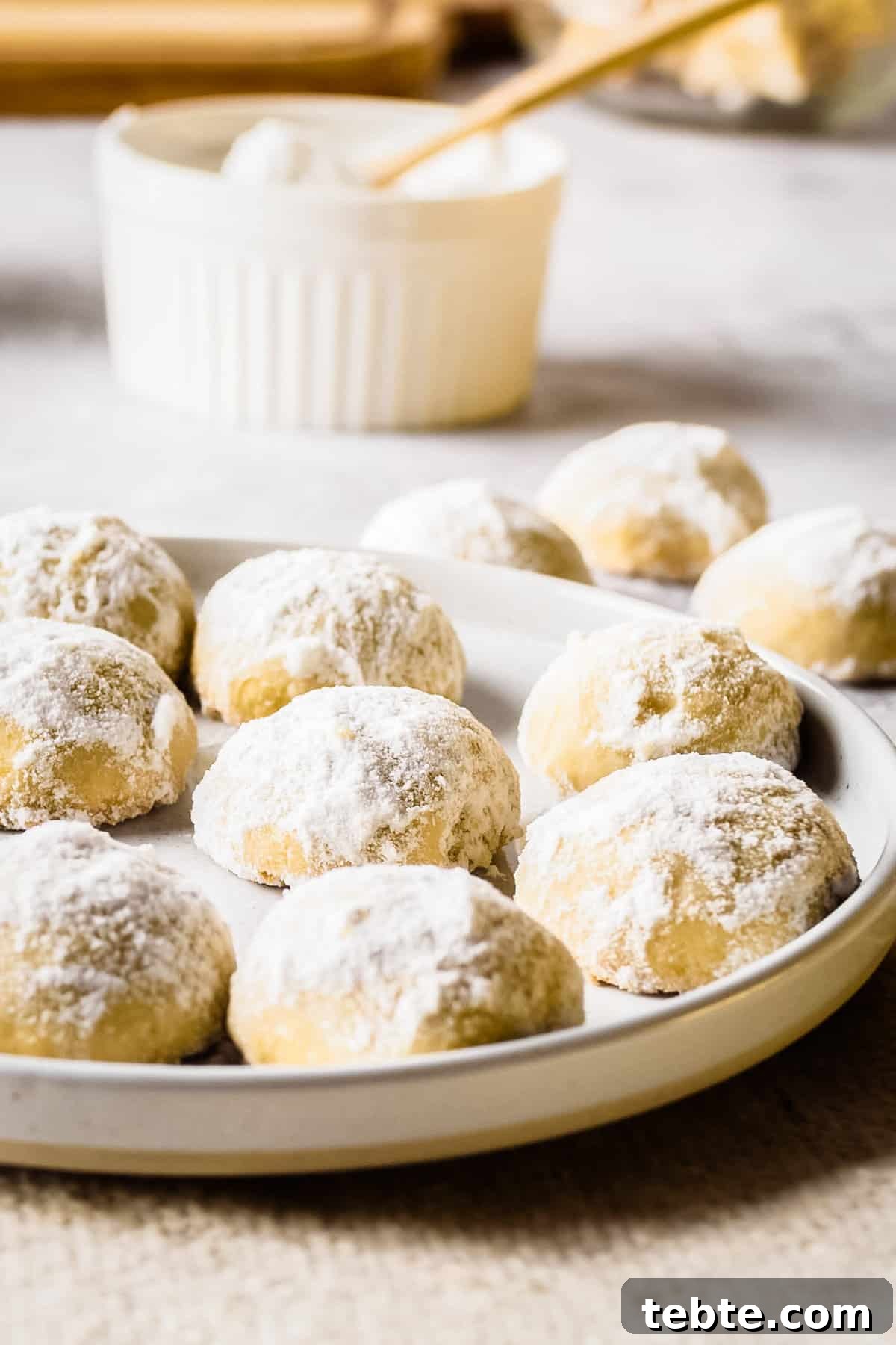 Close up view of holiday butter cookies on a white plate.