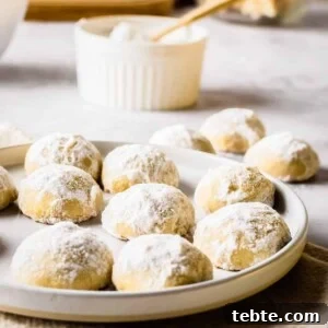 Close up view of holiday butter cookies on a white plate.