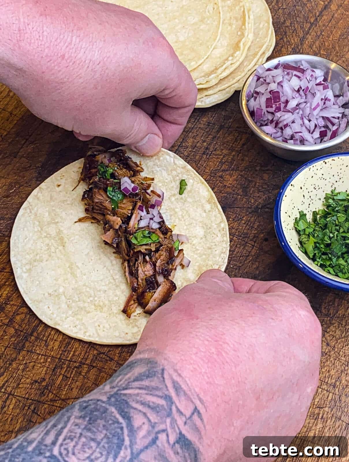 What to Make with Leftover Carnitas: Crispy Tacos & Bowls 6 assembling taquitos on a cutting board
