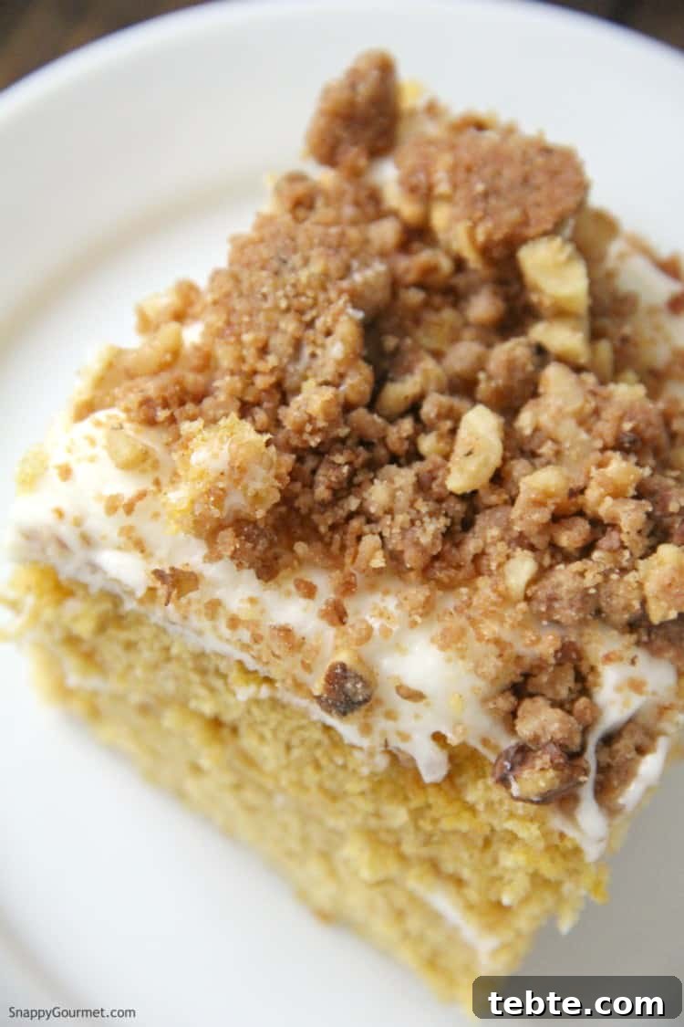 Pumpkin Crunch Cake with cream cheese frosting and crunch streusel topping top of Pumpkin Crunk Cake