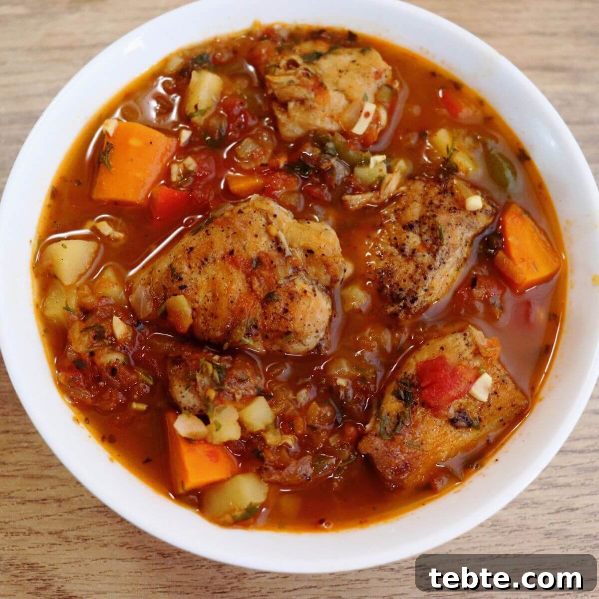 Mediterranean Chicken Stew with Olives, Tomatoes & Herbs 14 mediterranean chicken stew served in a white bowl.