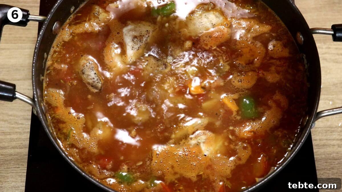Mediterranean Chicken Stew with Olives, Tomatoes & Herbs 9 addition of chicken and cooking the stew.