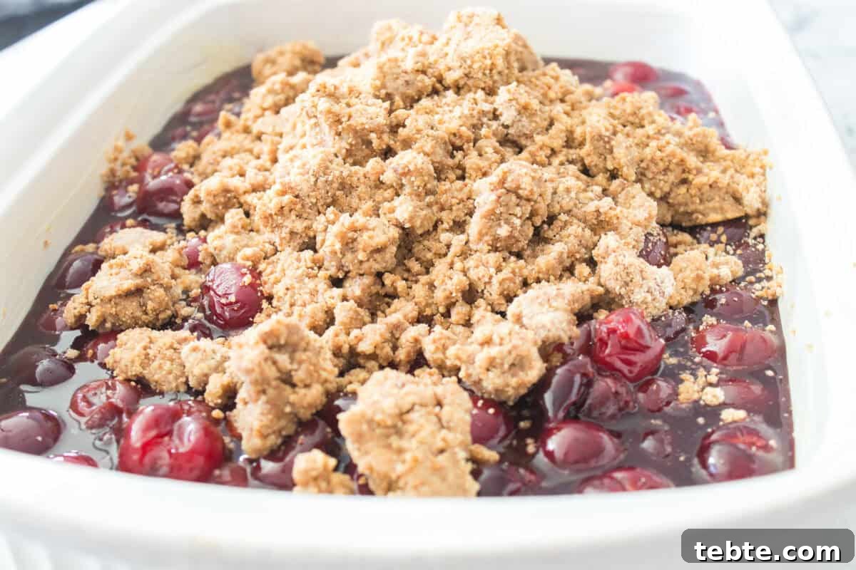 Gluten-Free Cherry Cobbler Recipe: Flaky Crust & Juicy Filling 6 cherry pie filling in bottom of casserole dish with crumb topping on top