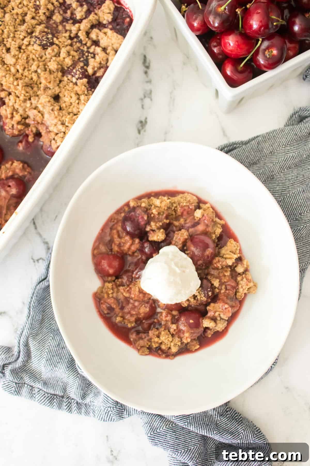 Gluten-Free Cherry Cobbler Recipe: Flaky Crust & Juicy Filling 9 vertical overhead shot of gluten-free cherry cobbler served with scoop of vanilla ice cream