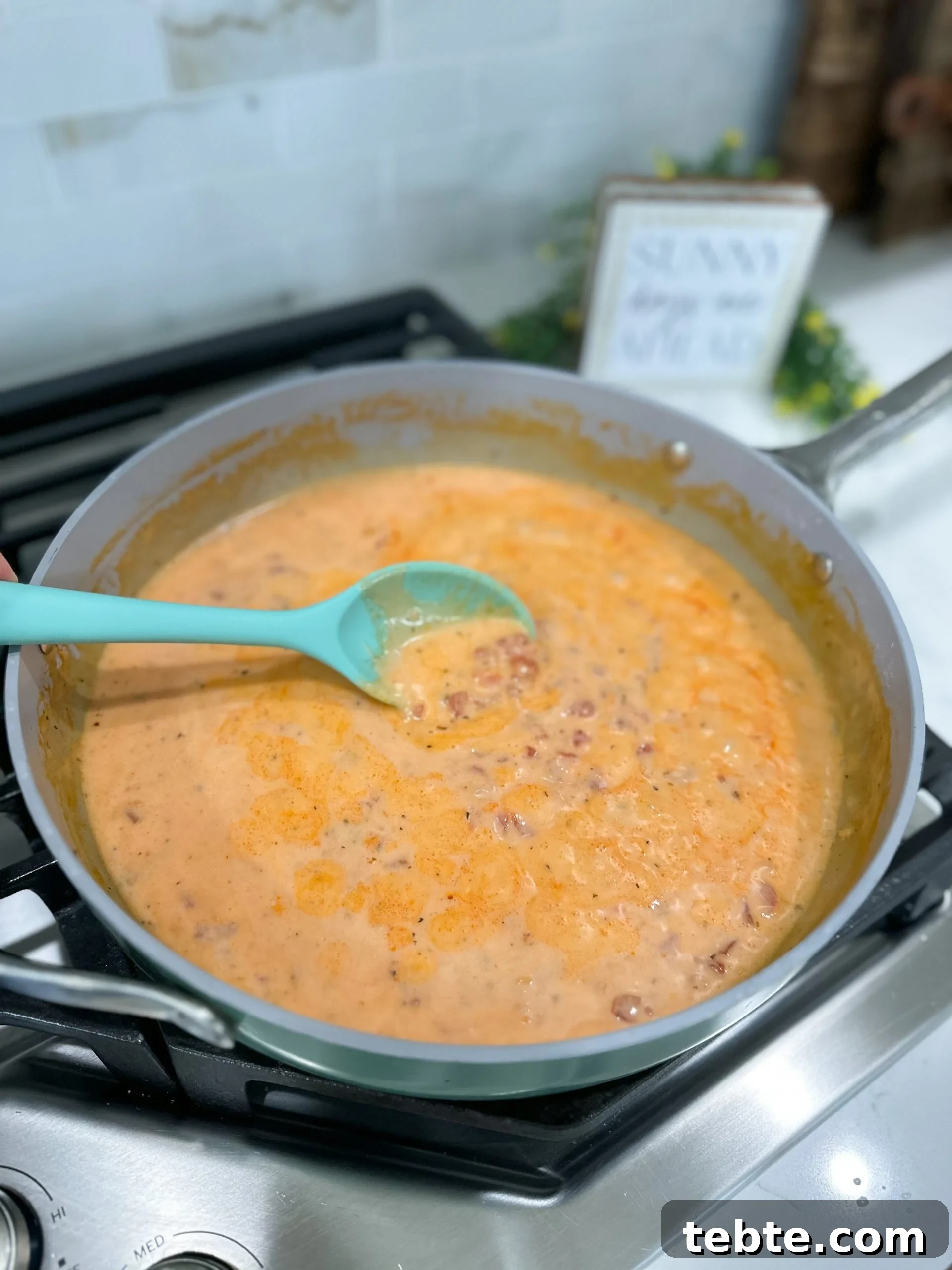 Creamy Tomato and Bacon Pasta Recipe for Weeknight Dinners 5 Alfredo and tomato sauce simmering in a skillet