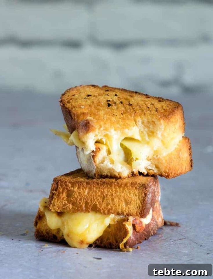 Two halves of the completed Air Fryer Grilled Cheese sandwich stacked and ready to serve