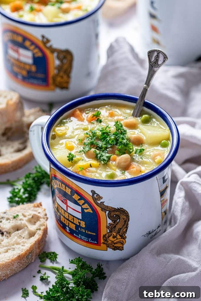 vegetable soup in a blue and white enamel mug.