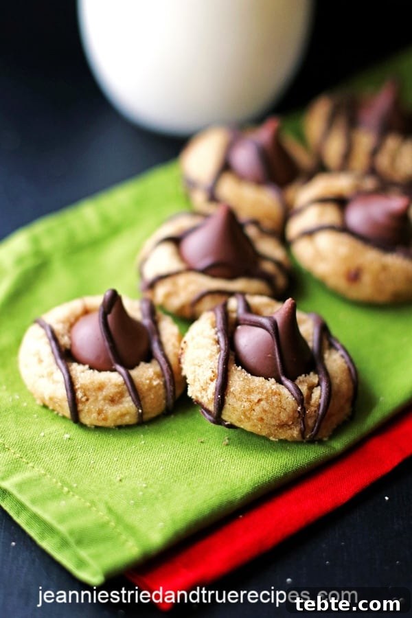 Peanut Butter Kiss Cookies Recipe — Chewy Chocolate-Stamped Treats 2 Peanut Butter Kiss Cookies on green and red napkins
