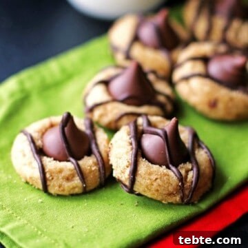 Peanut Butter Kiss Cookies Recipe — Chewy Chocolate-Stamped Treats 9 Peanut Butter Kiss Cookies on green and red napkins