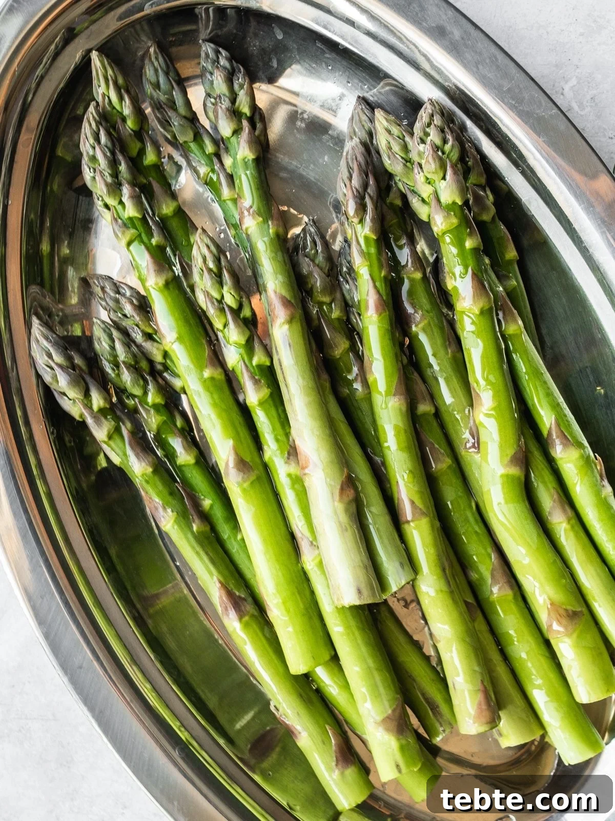 Grilled Asparagus and White Bean Salad with Lemon Vinaigrette 5 Trimmed and oiled asparagus spears in a tray.