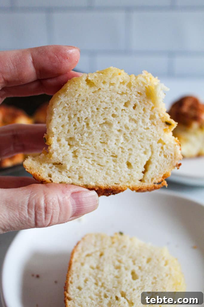 Gluten-Free Dairy-Free Parmesan-Style Pull-Apart Rolls 3 hand holding a gluten free parmesan roll.