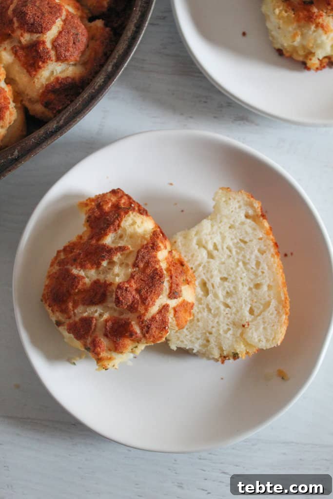 Gluten-Free Dairy-Free Parmesan-Style Pull-Apart Rolls 8 gluten free parmesan roll split in half on a white plate.