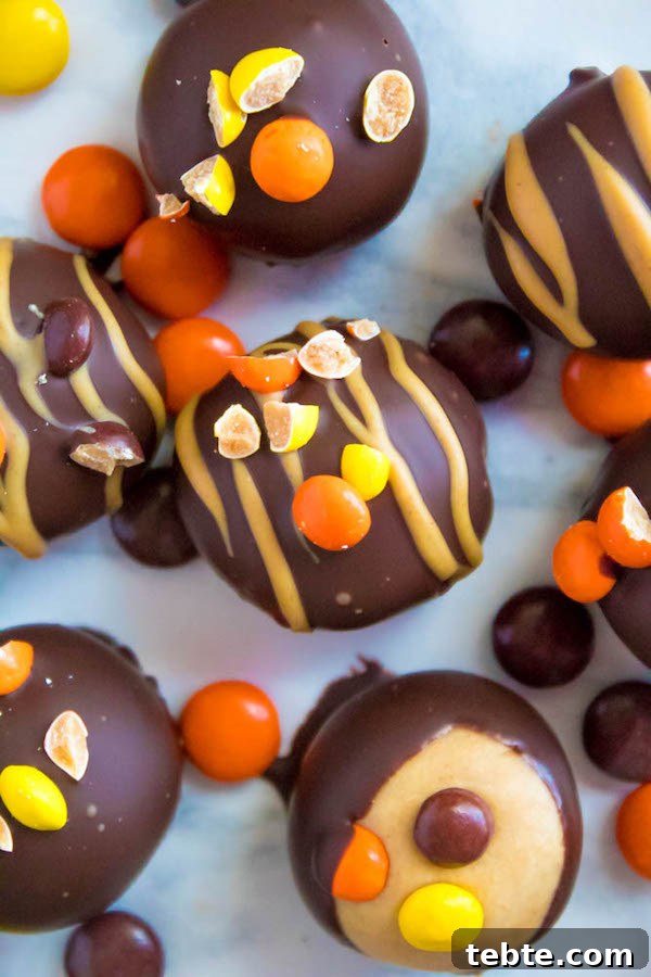 Reese’s Pieces Peanut Butter Truffle Recipe for Candy Lovers 2 Reese's Pieces Peanut Butter Truffles— smooth and creamy peanut butter balls, loaded with mini Reese's Pieces, coated with dark chocolate and drizzled with melted peanut butter!