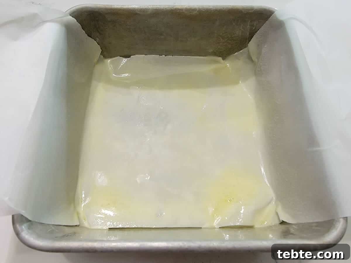 Small-Batch Rice Krispie Treats Recipe 3 a 6 inch cake pan filled with parchment paper sprayed with non-stick spray.