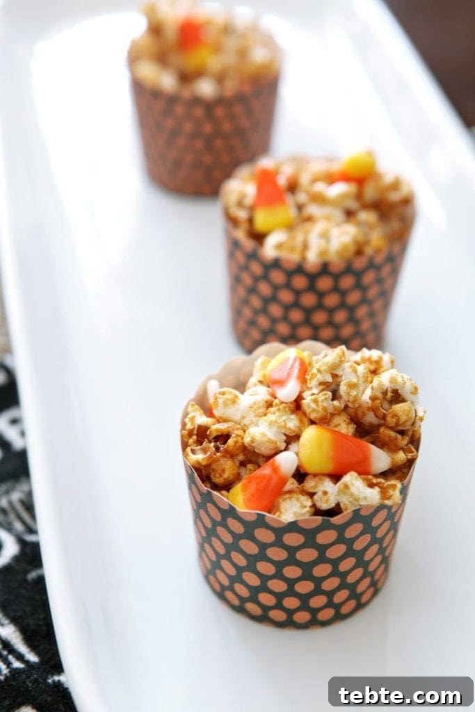 Halloween Caramel Corn Recipe: Sweet & Crunchy Party Snack 2 Three bowls filled with popcorn and candy corn on white plate